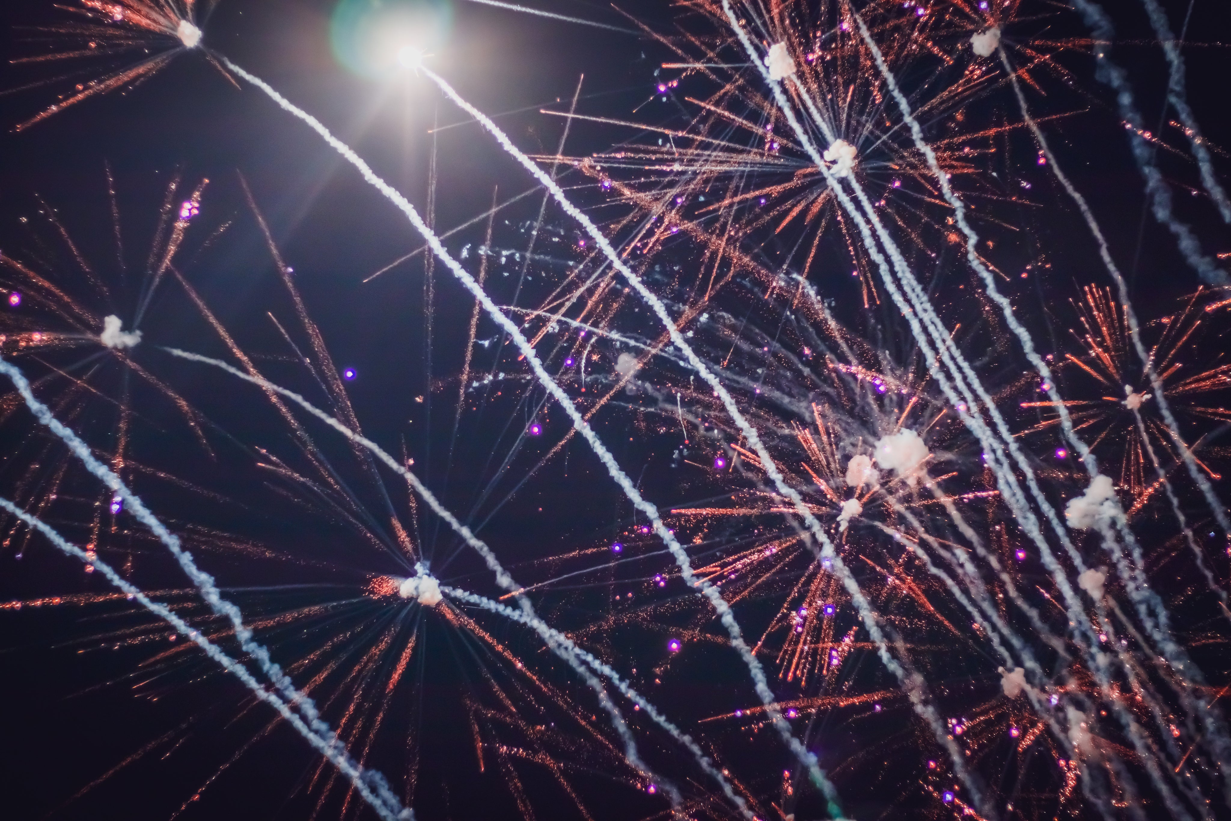 Fireworks streaking across a black sky display for Red Apple fireworks